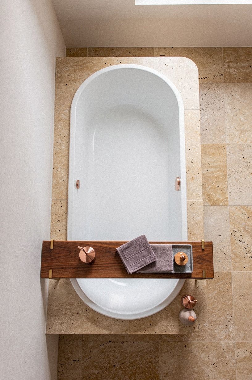 Layer a teak shelf over the tub