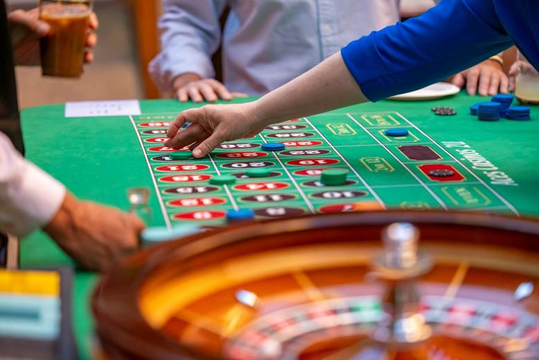 A group of people playing roulette

AI-generated content may be incorrect.