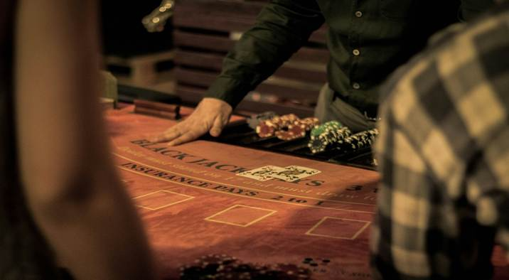 A person at a table with poker chips and cards

AI-generated content may be incorrect.